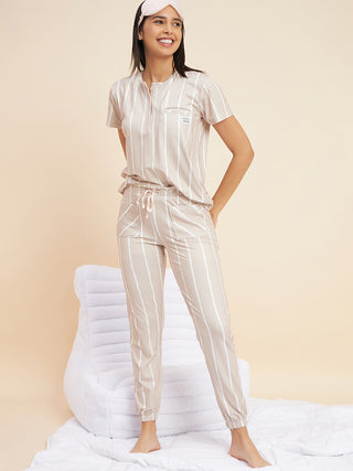 a women with standing iconic pose wearing beige zigzag jogger set made of cloud soft