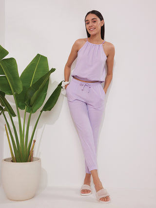 a women  standing wearing lavender ecstasy jogger set  made of waffles