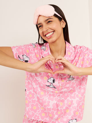a women wearing a pink bloom snoopy blooms shorts set made of cloud soft